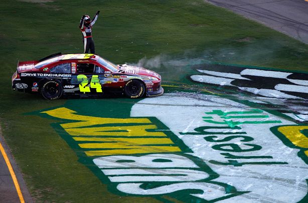 Jeff Gordon gets out of his car to salute the fans after winning the SUBWAY Fresh Fit 500 at Phoenix International Raceway, ending a 66-race winless streak. Credit: Todd Warshaw/Getty Images for NASCAR